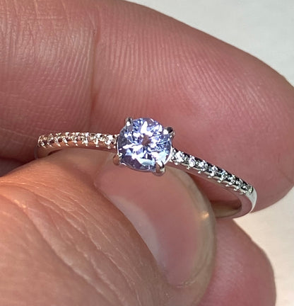 Sterling silver ring with a light violet tanzanite and small accent stones.