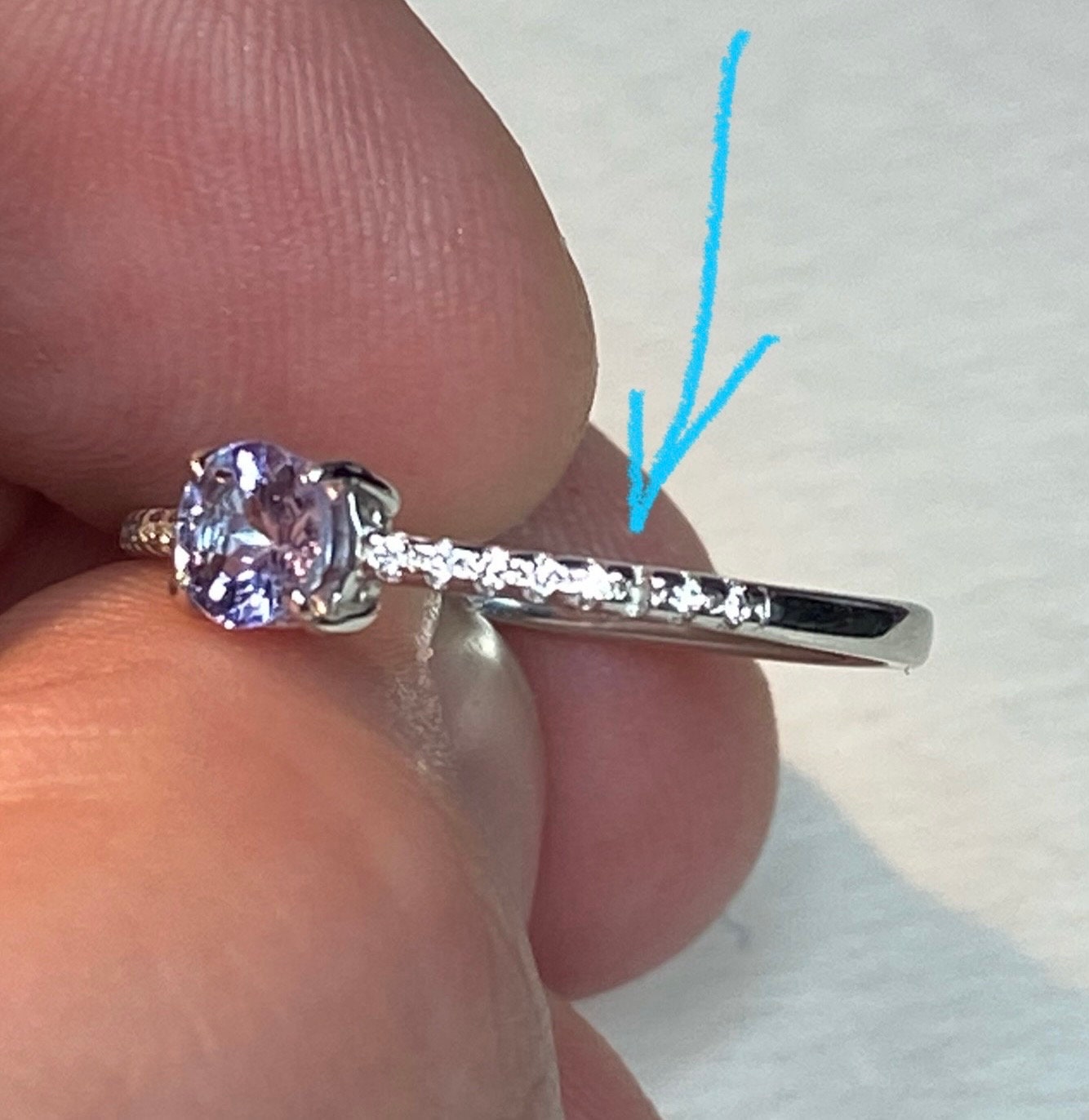 Sterling silver ring with a tanzanite solitaire and small accent stones.