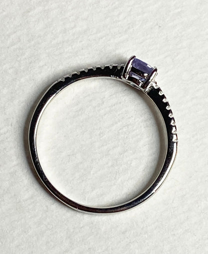 Sterling silver ring with a round tanzanite and small accent stones.