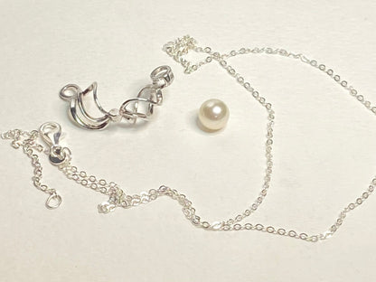 Sterling silver pendant with a pearl in a cage and a cable chain.
