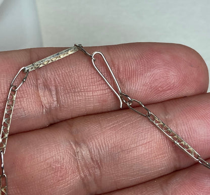 Antique sterling silver filigree cross pendant with a hook clasp chain.