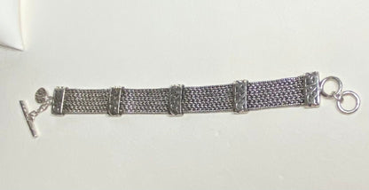 Lois Hill wide woven sterling silver bracelet with toggle clasp.