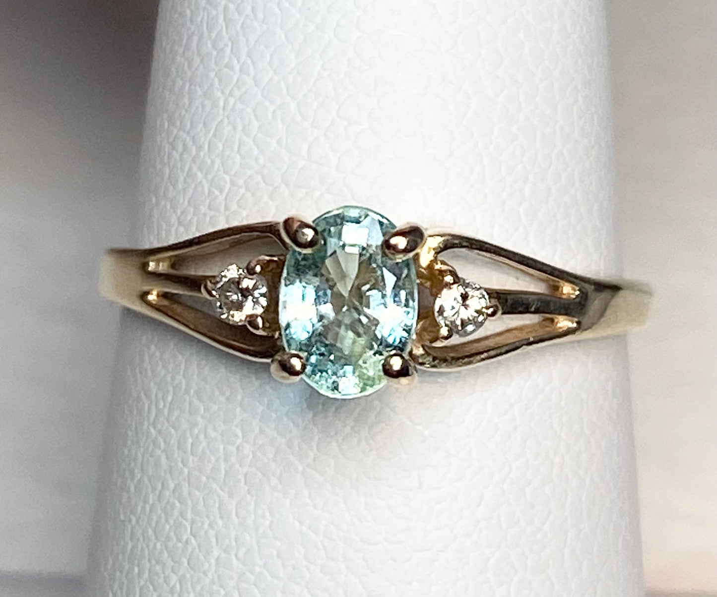 14k gold ring with oval "Paraiba colored" tourmaline and two diamonds.