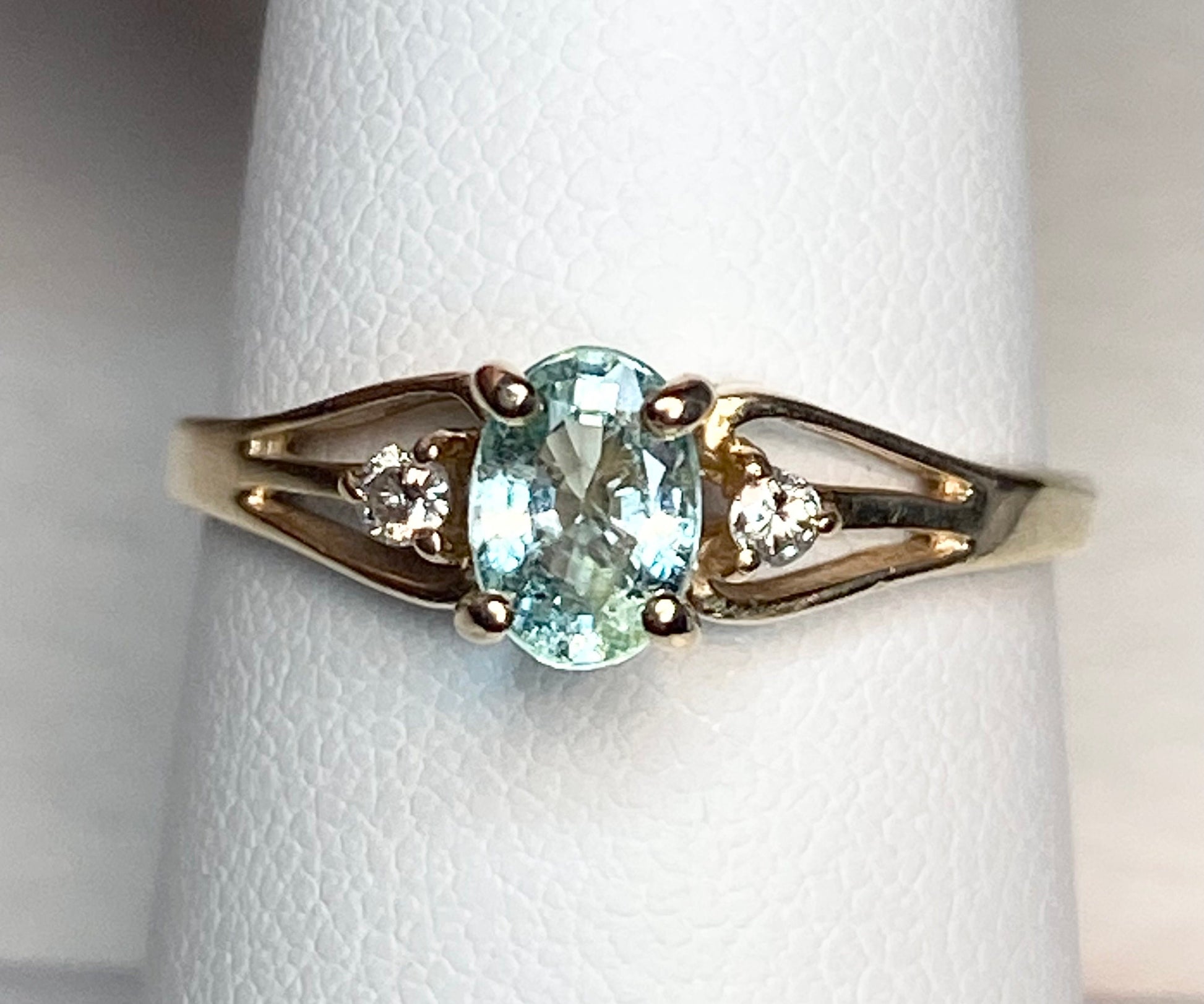 14k gold ring with oval "Paraiba colored" tourmaline and two diamonds.