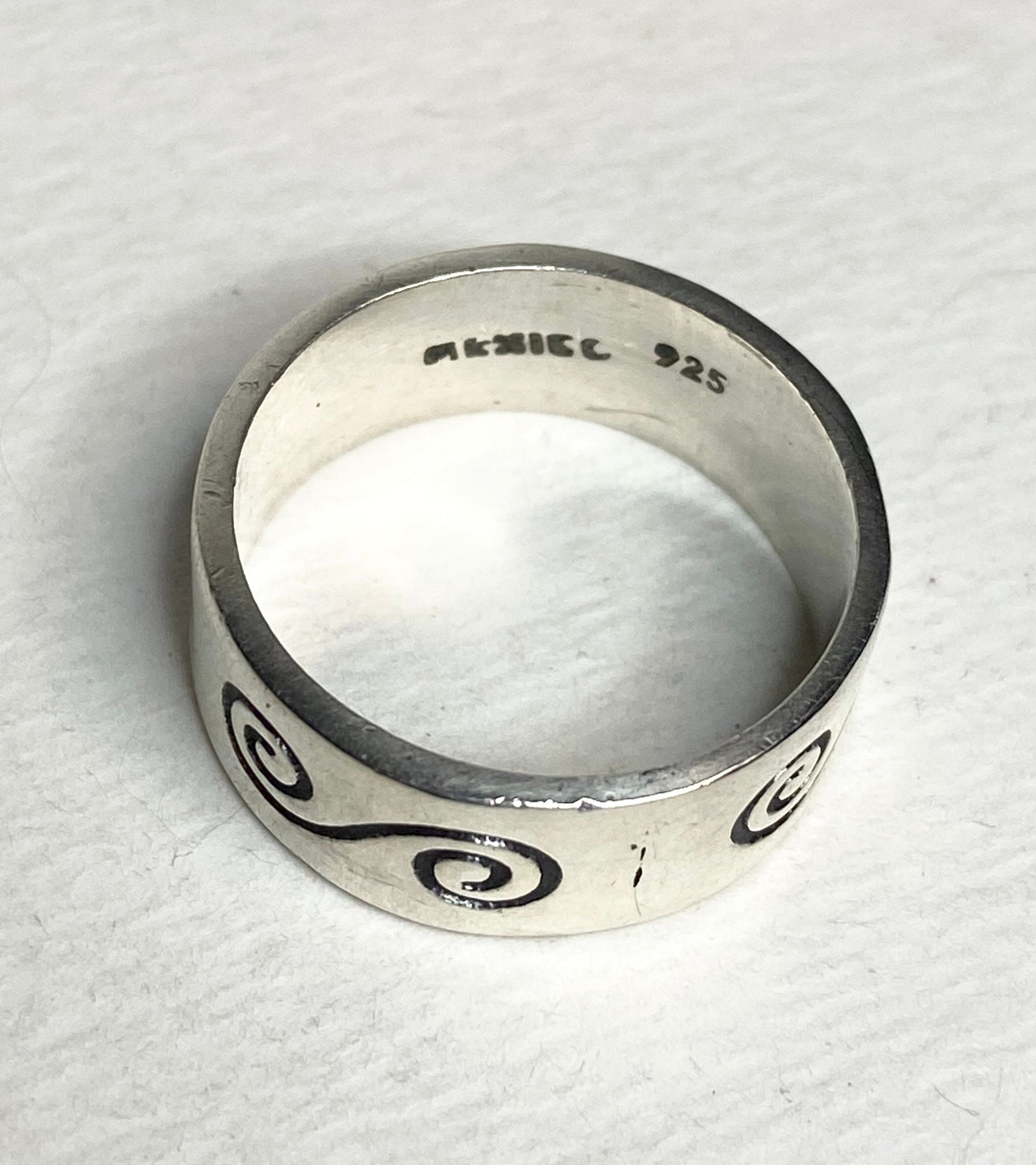 Mexican sterling silver band ring with swirl design and "925 Mexico" stamp.
