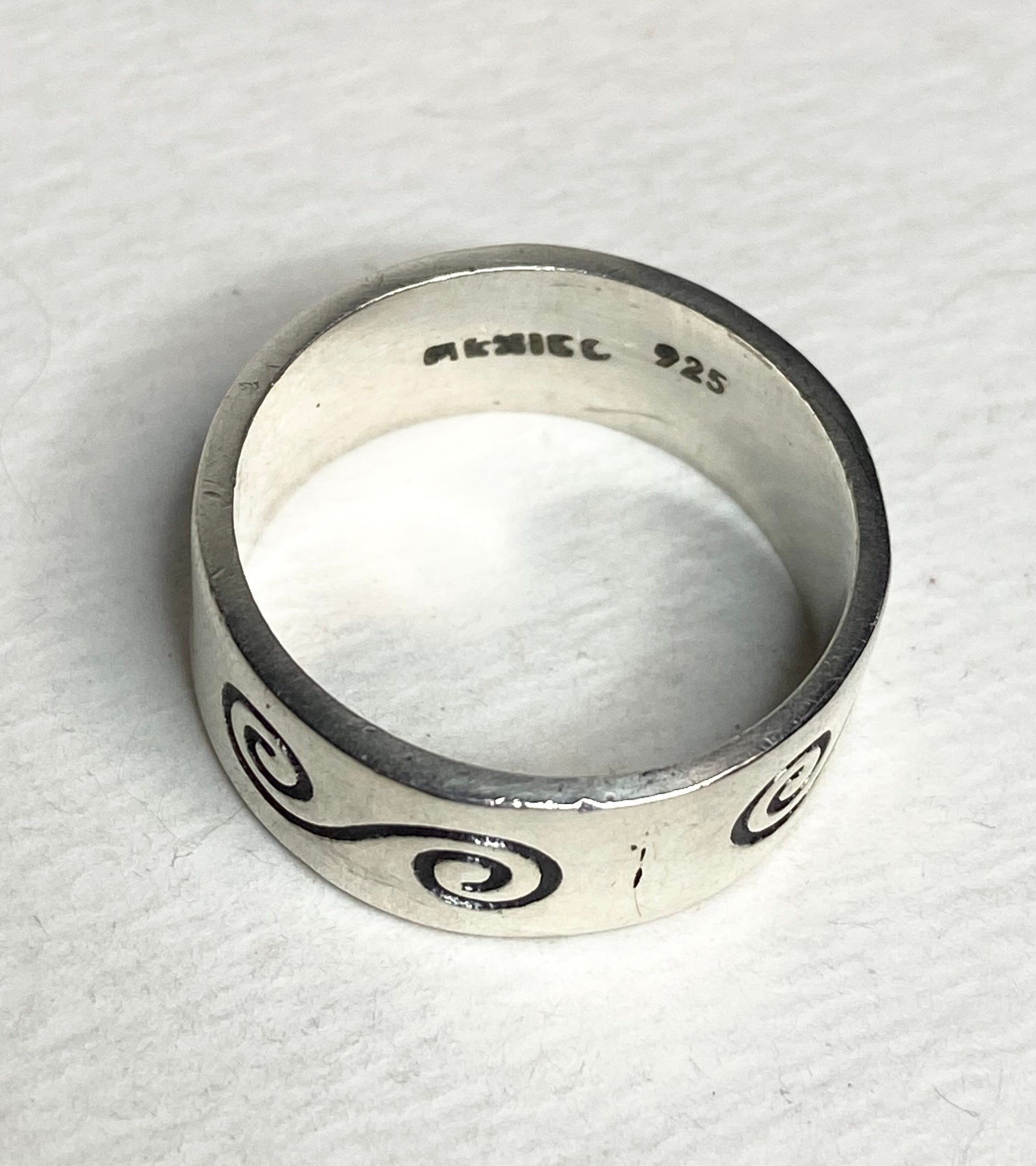 Mexican sterling silver band ring with swirl design and "925 Mexico" stamp.
