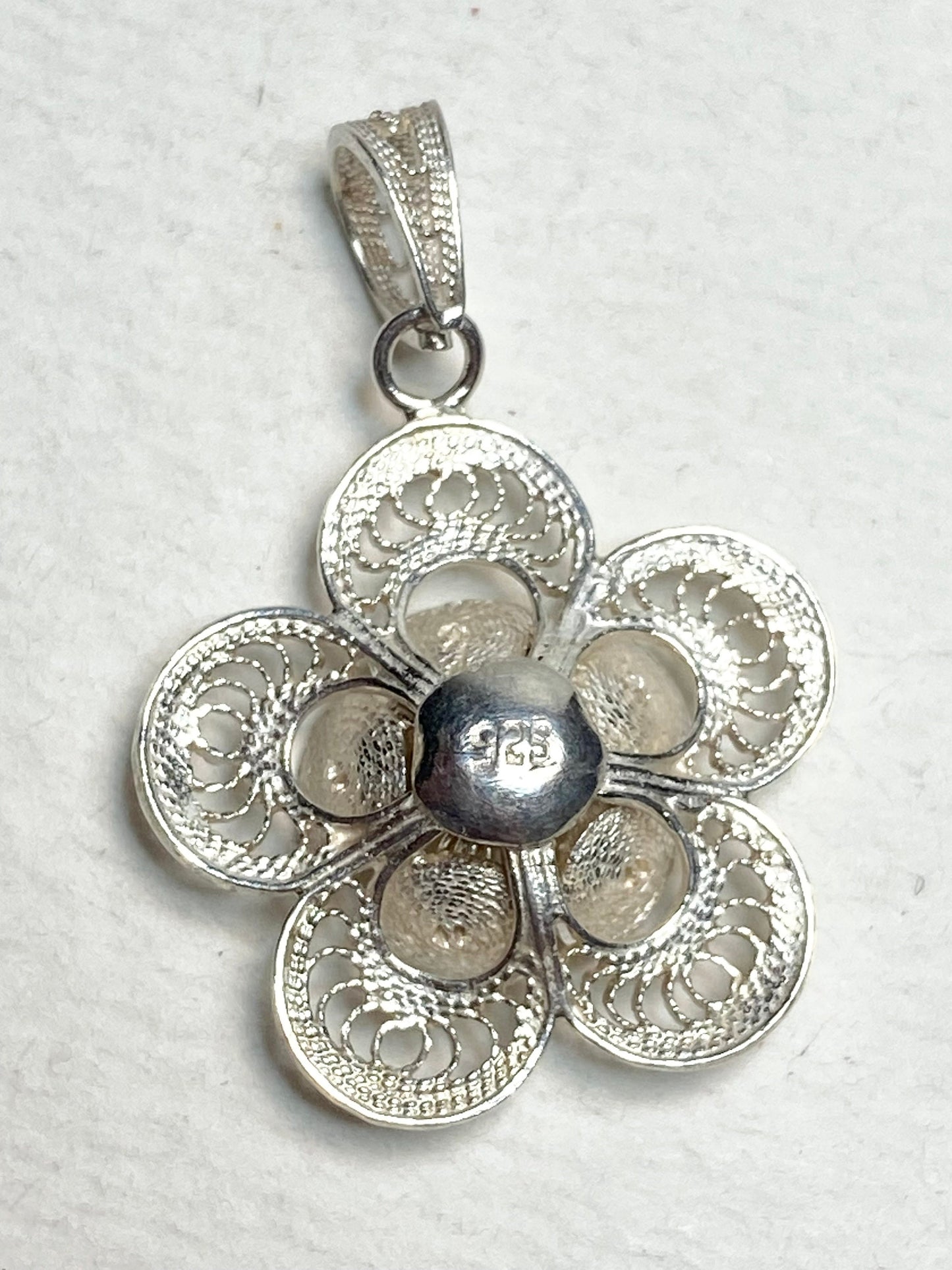 Handmade sterling silver filigree flower pendant with a 925 stamp.