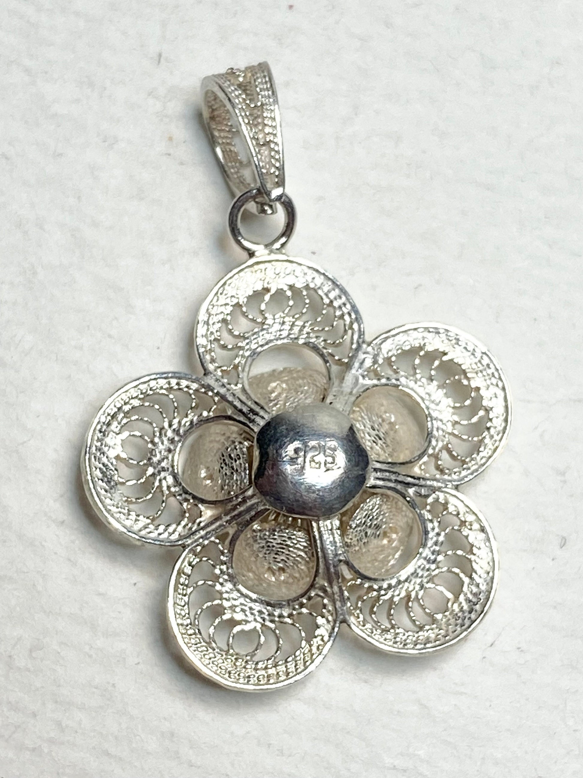 Handmade sterling silver filigree flower pendant with a 925 stamp.
