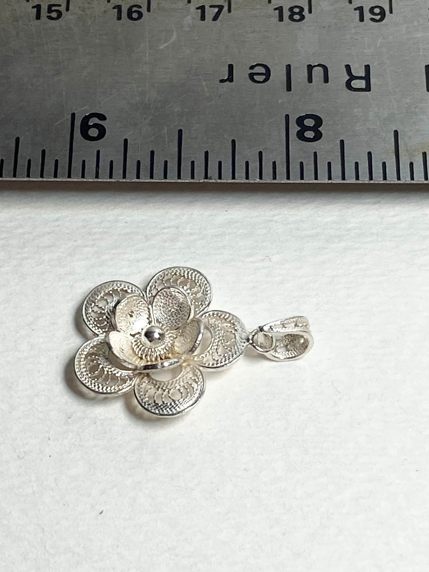 Sterling silver filigree flower pendant.