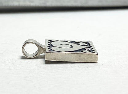Sterling silver square pendant with heart and stars design.