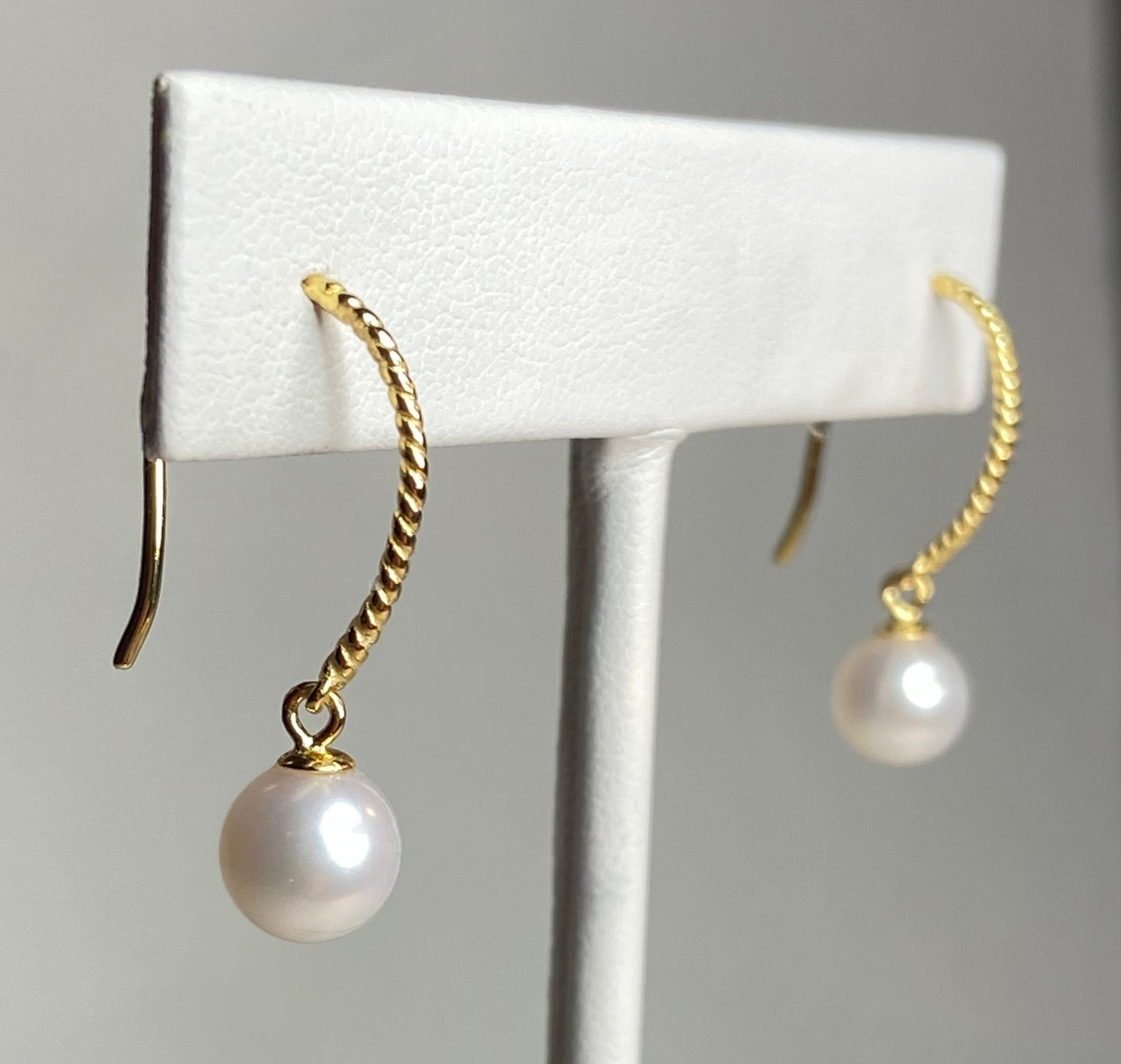 Gold plated sterling silver dangle earrings with 7mm cultured pearls.