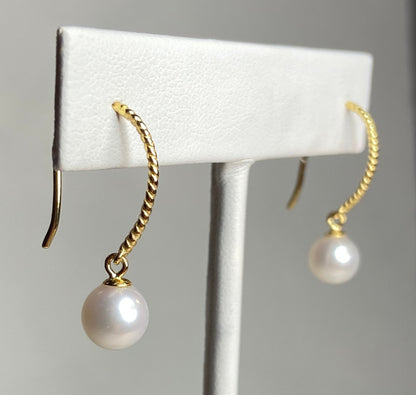 Gold plated sterling silver dangle earrings with 7mm cultured pearls.