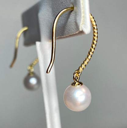 Gold plated sterling silver dangle earrings with 7mm cultured pearls.