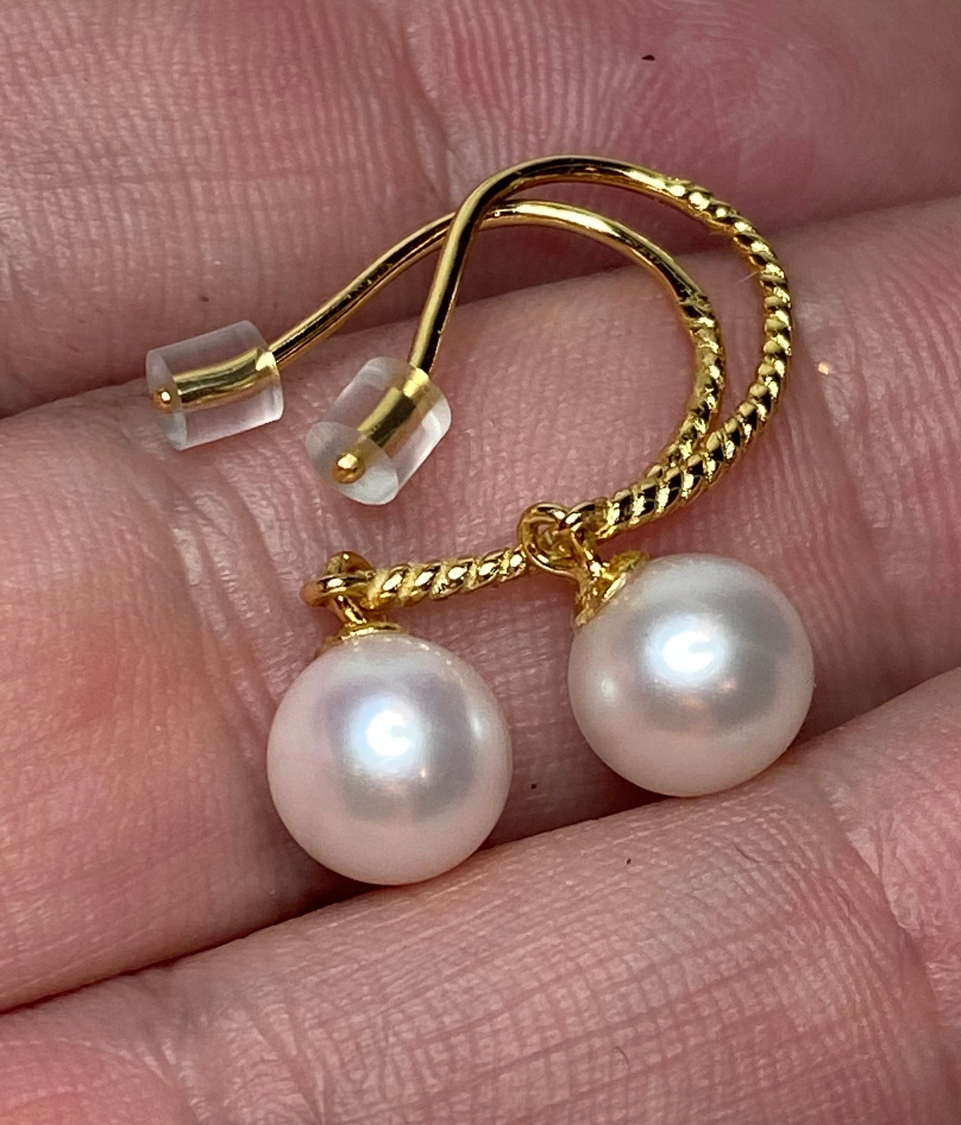 Gold plated sterling silver earrings with 7mm cultured pearls and twisted wire hooks.