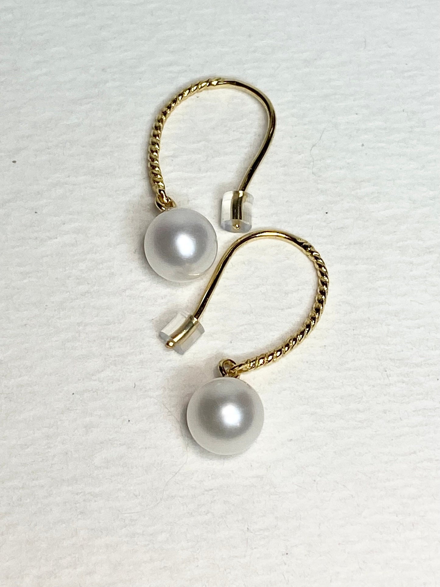 Gold plated sterling silver dangle earrings with 7mm cultured pearls.