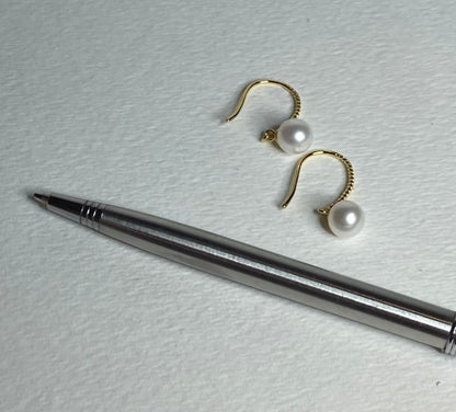 Gold plated sterling silver earrings with 7mm cultured pearls and twisted wire hooks.