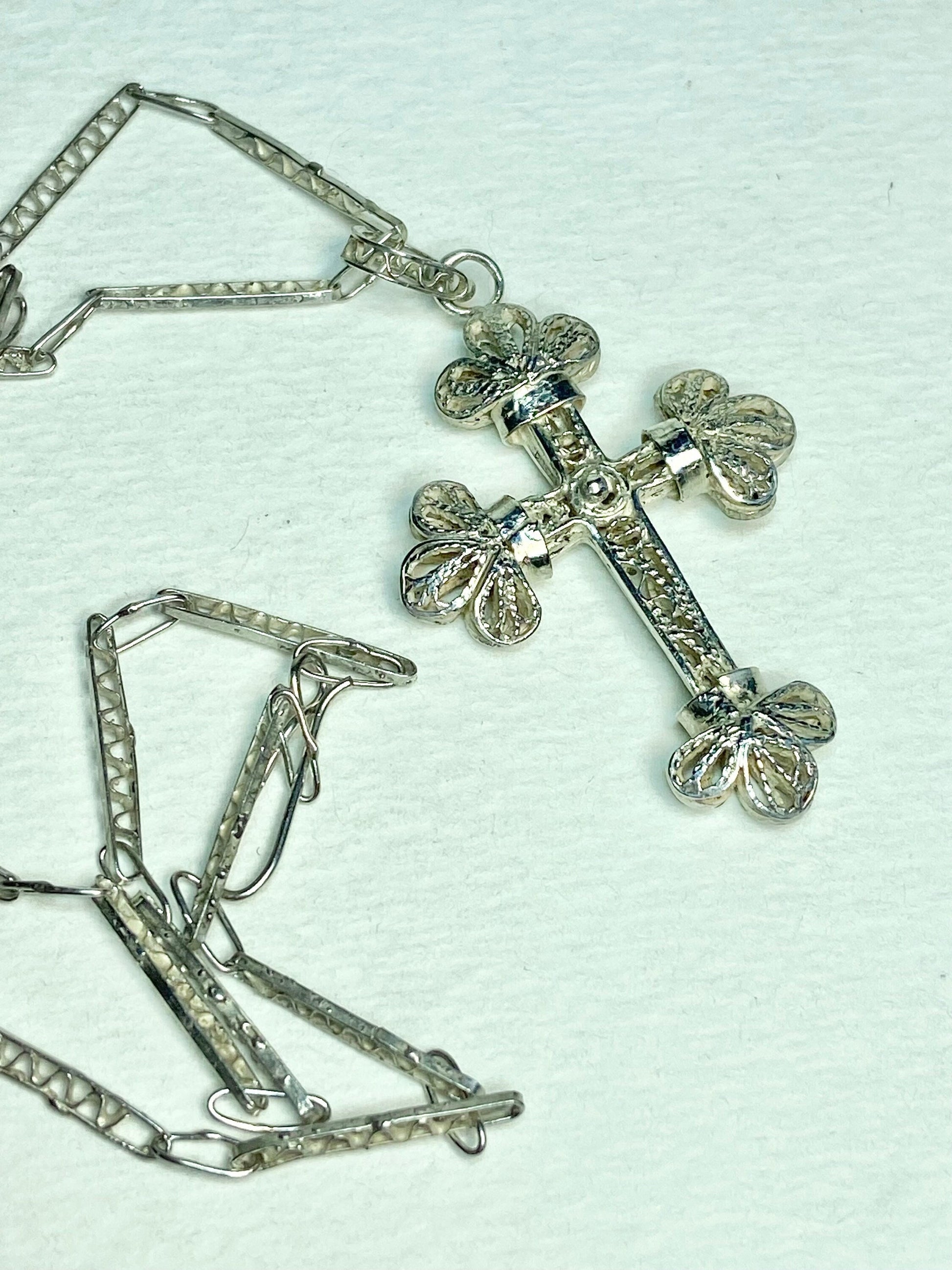 Antique sterling silver filigree cross pendant with a matching chain.