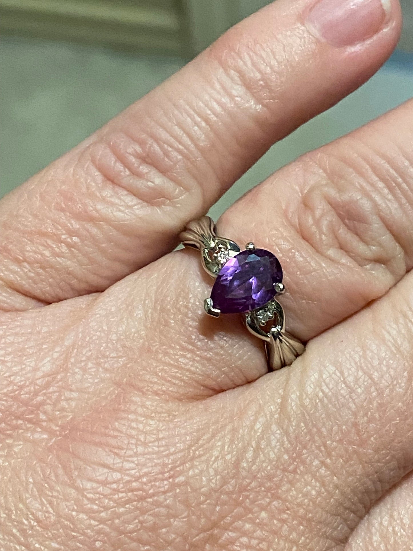 10k white gold ring with pear-shaped synthetic sapphire and diamonds.