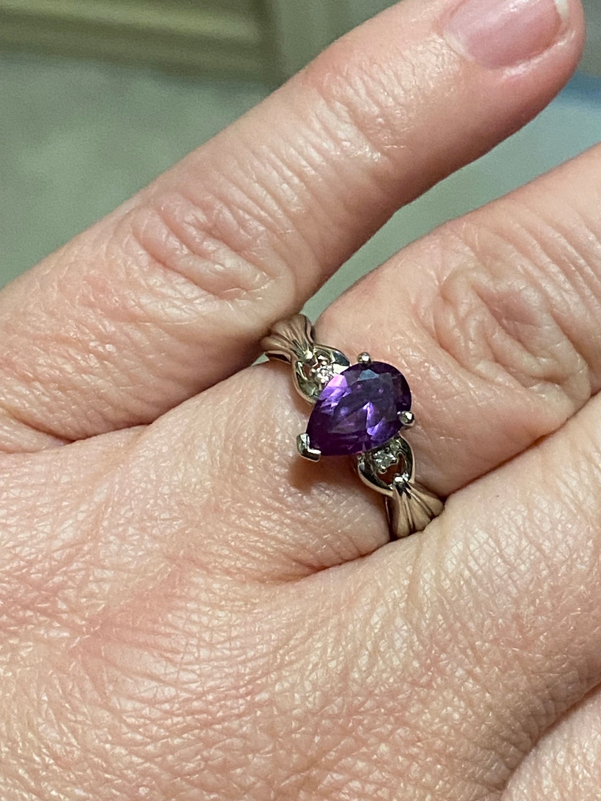 10k white gold ring with pear-shaped synthetic sapphire and diamonds.