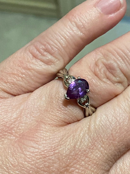 10k white gold ring with pear-shaped synthetic sapphire and diamonds.