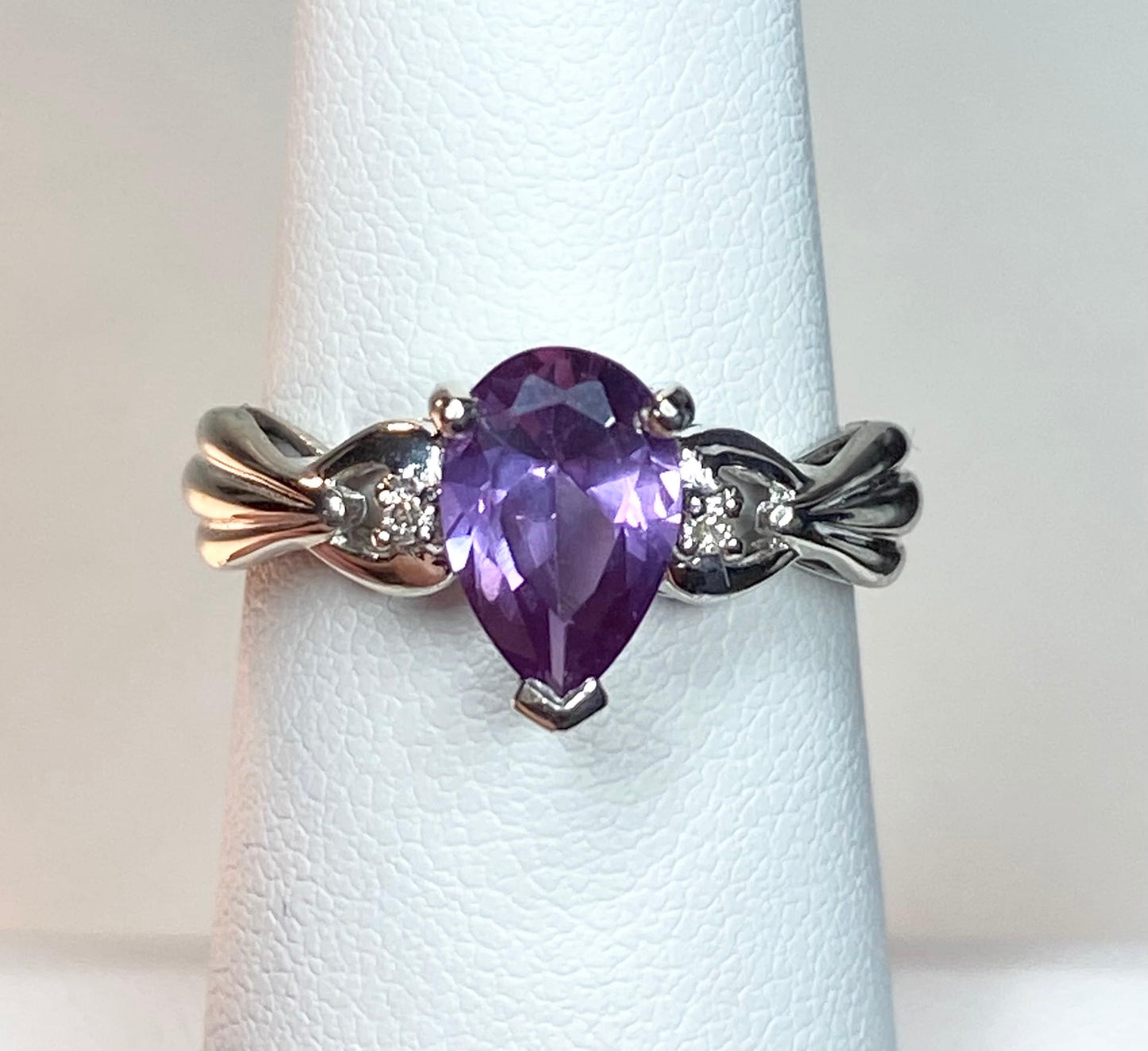 10k white gold ring with a pear-shaped synthetic color change sapphire and diamonds.