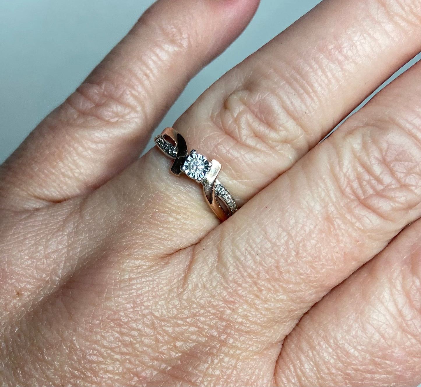10k rose gold and sterling silver bypass ring with diamonds.