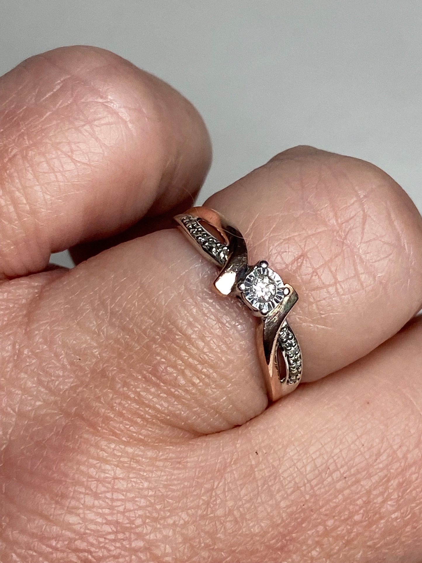 10k rose gold and sterling silver bypass ring with diamonds.