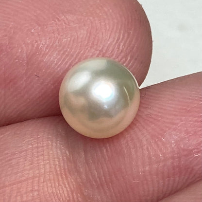 Soft cream Akoya pearl in a sterling silver cage pendant.