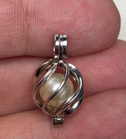 Sterling silver pendant with a soft cream Akoya pearl in a cage.