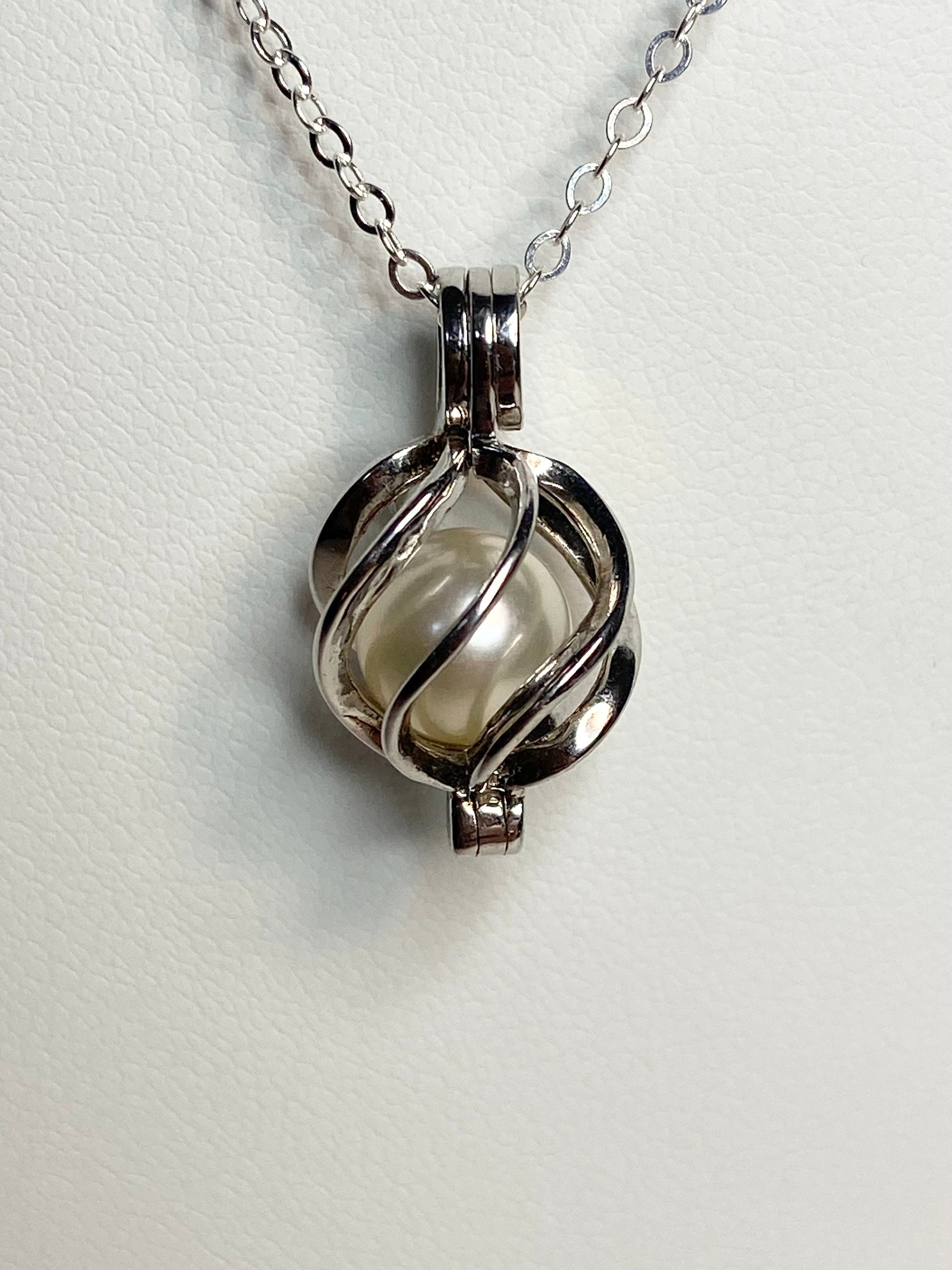 Sterling silver pendant necklace with a 7.8mm Akoya pearl in a cage.