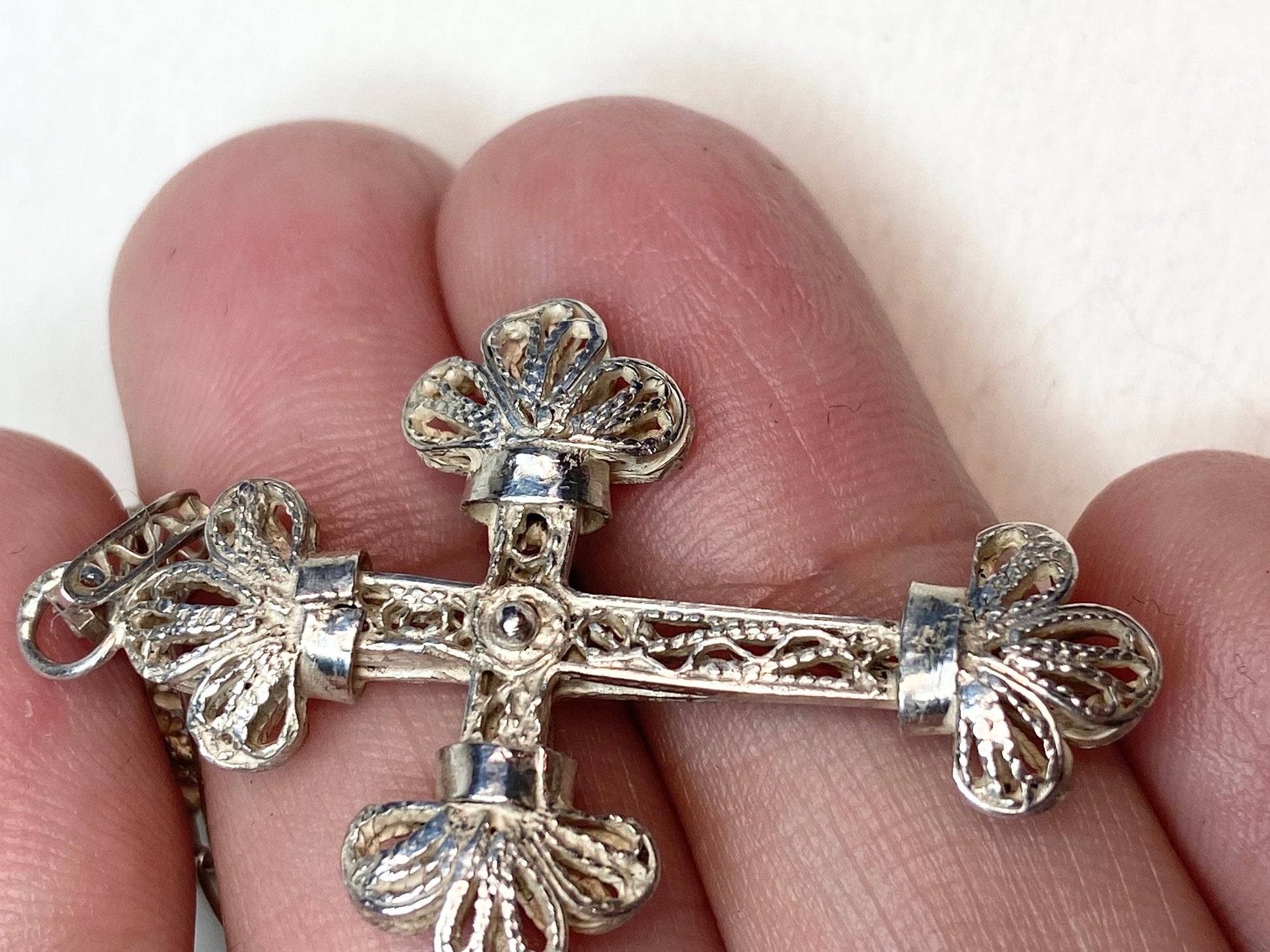 Antique filigree sterling silver cross pendant with a matching chain.