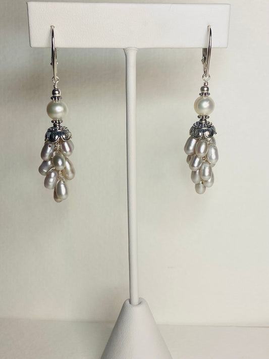 Silver dangle earrings with white freshwater pearls and lever backs.