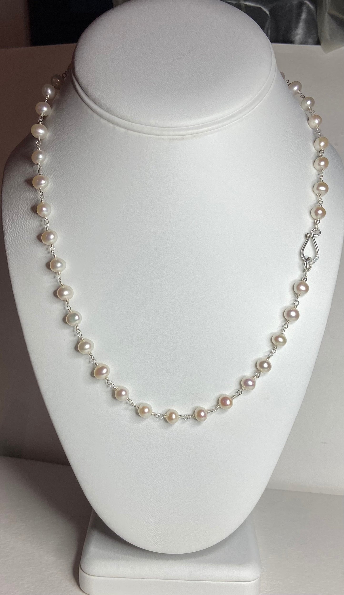 Lustrous genuine cultured freshwater pearls on a sterling silver chain with a hook clasp.