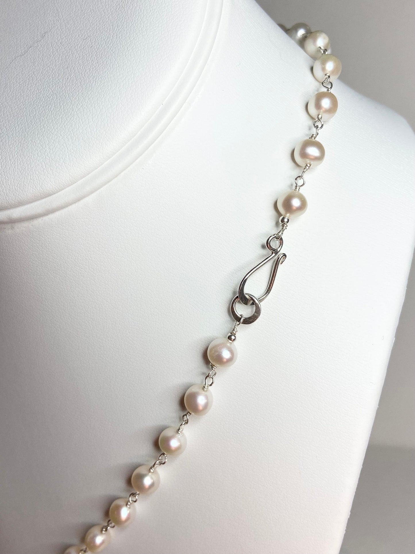 Lustrous genuine cultured freshwater pearls on a sterling silver necklace with a hook clasp.