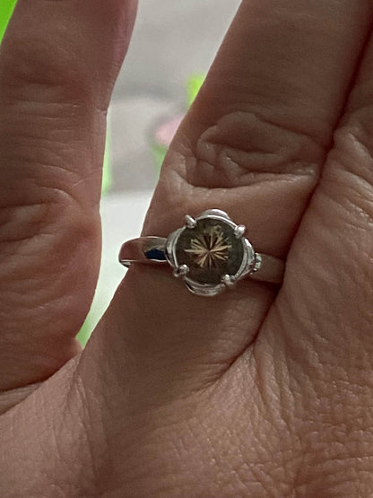 Sterling silver ring with a round, 1.18ct Oregon Sunstone in a floral setting.