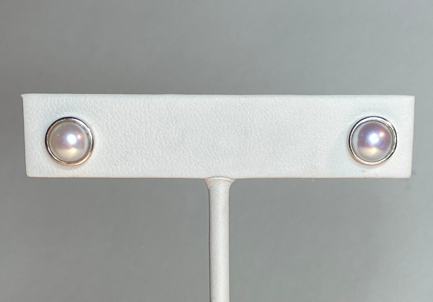 Genuine 6.5mm cultured pearl halves in sterling silver bezel stud earrings.