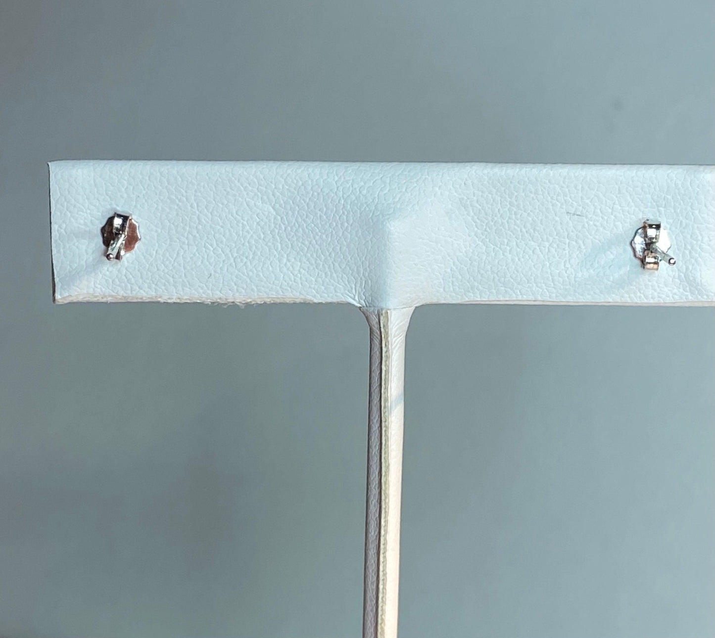 Genuine 6.5mm cultured pearl halves in sterling silver bezel stud earrings.