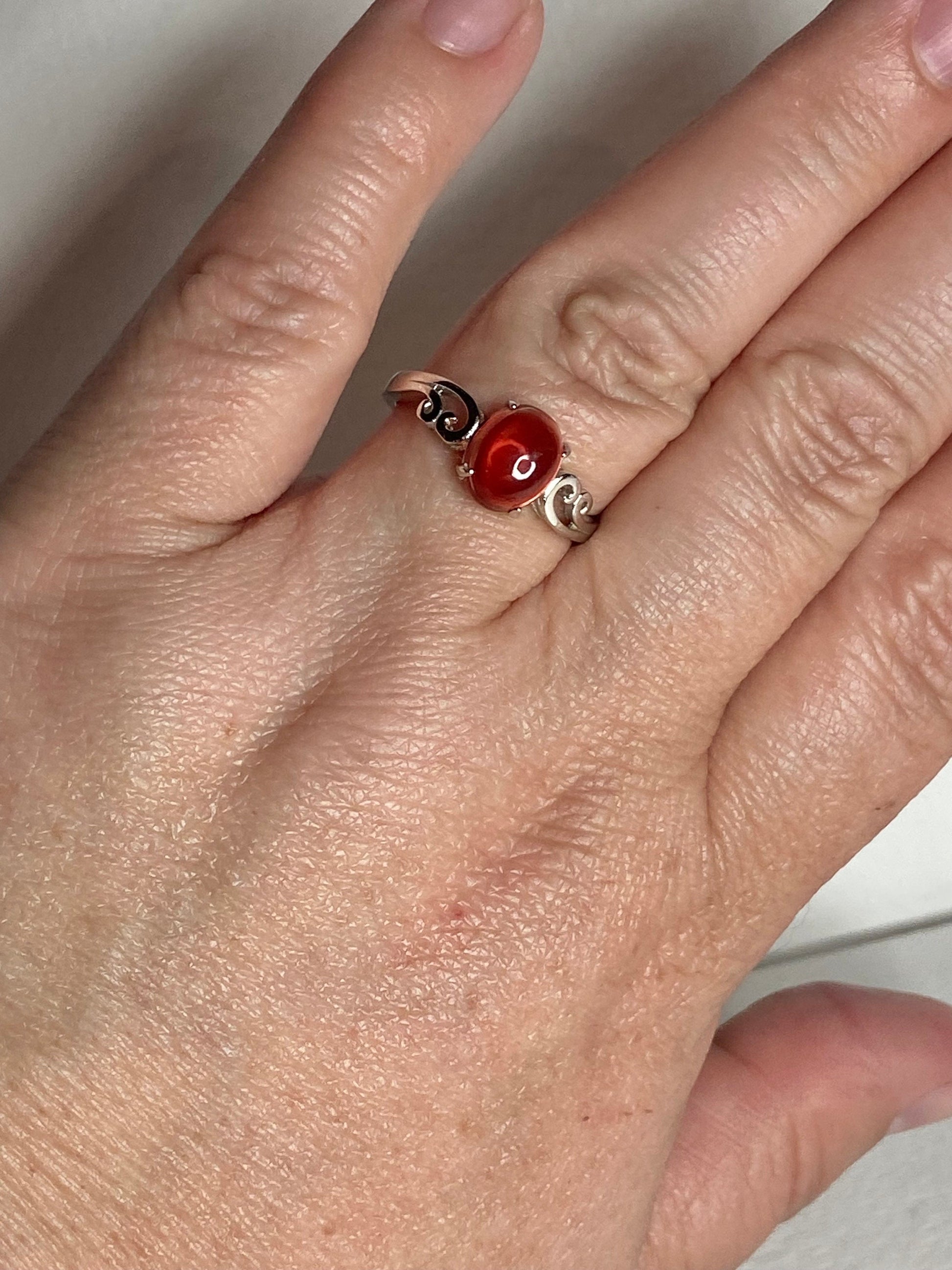 Red Oregon sunstone cabochon swirl ring in solid sterling silver.