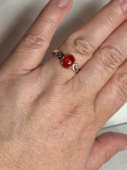 Red Oregon sunstone cabochon swirl ring in solid sterling silver.