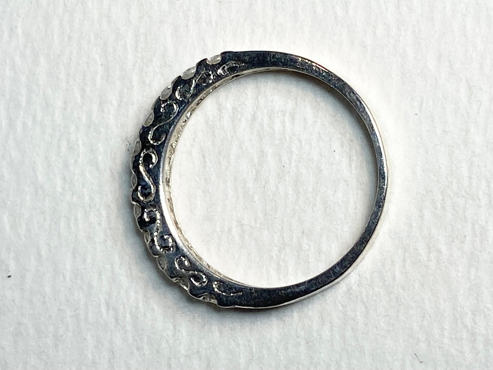 Silver anniversary stackable band ring with cz crystals.