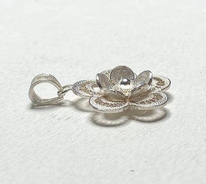 Sterling silver filigree flower pendant with a textured bail.