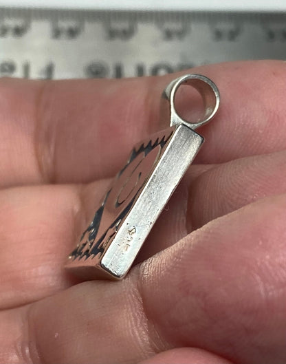 Sterling silver square pendant with heart and stars design.