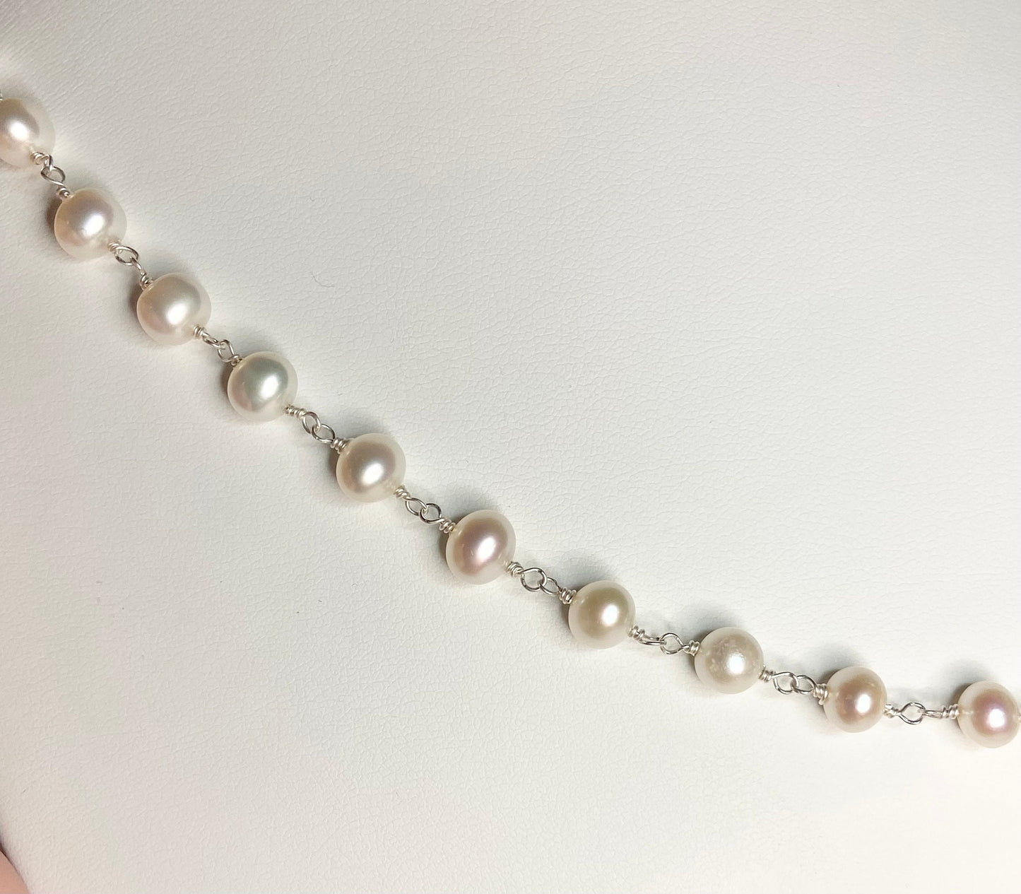 Lustrous genuine cultured freshwater pearls on a sterling silver chain.