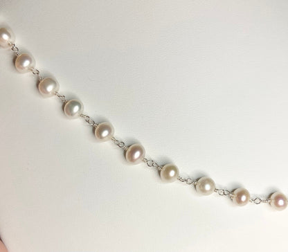 Lustrous genuine cultured freshwater pearls on a sterling silver chain.