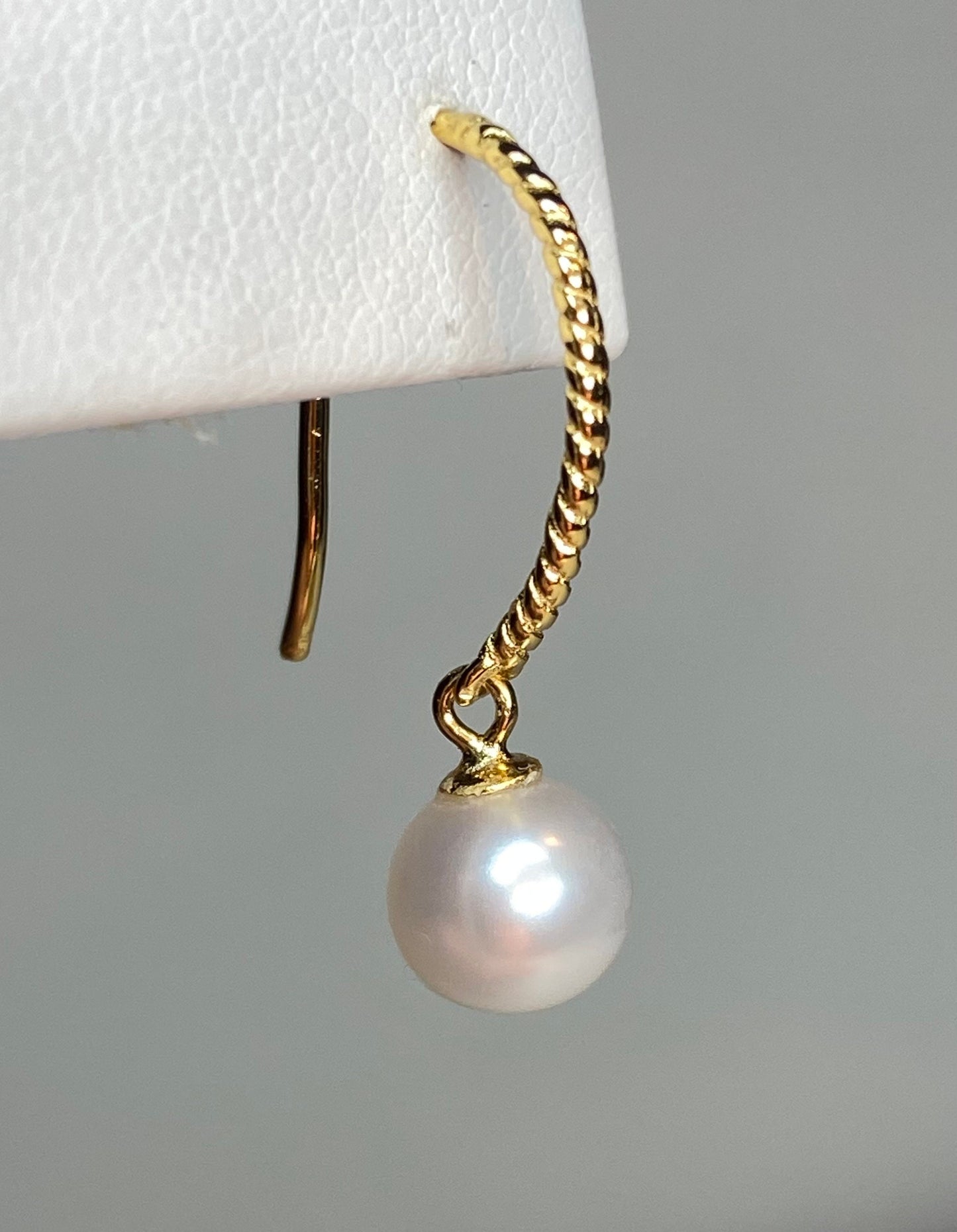 Gold plated sterling silver earrings with a twisted wire hook and a 7mm cultured pearl dangle.