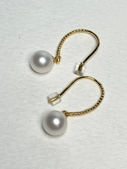 Gold plated sterling silver dangle earrings with 7mm cultured pearls and twisted wire hooks.