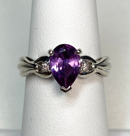 10k white gold ring with pear-shaped synthetic sapphire and diamonds.