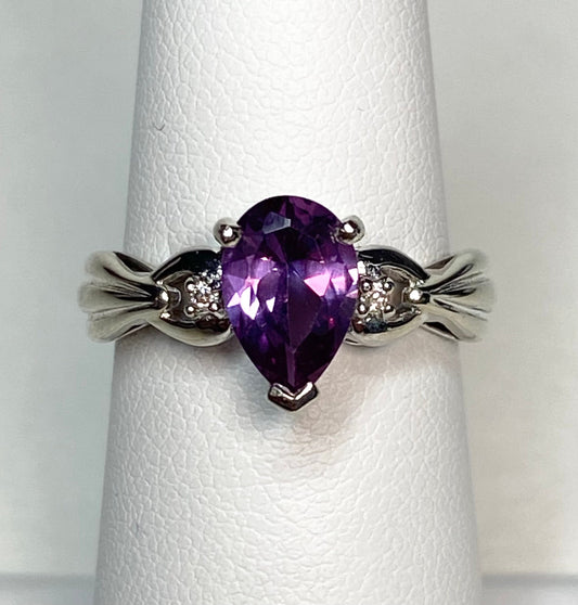 10k white gold ring with pear-shaped synthetic sapphire and diamonds.