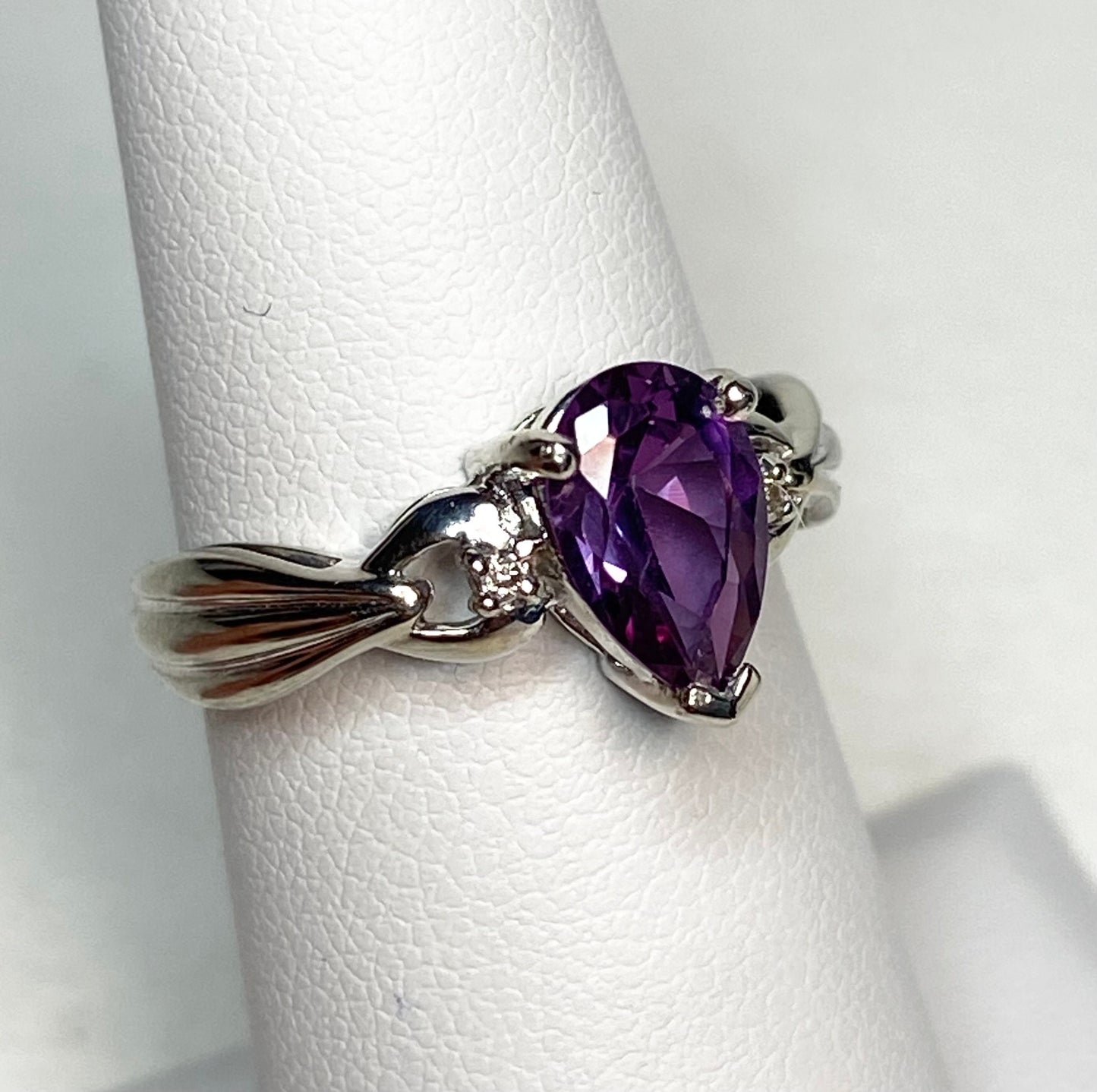 10k white gold ring with a pear-shaped synthetic color change sapphire and natural diamonds.