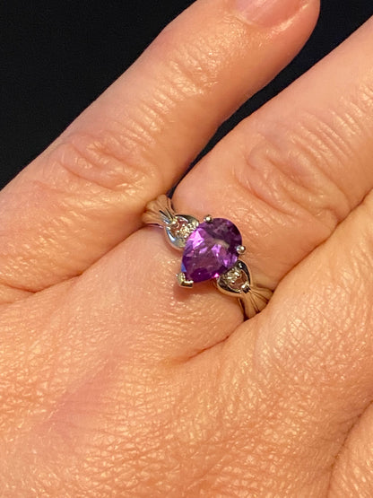 10k white gold ring with a pear-shaped color-change sapphire and diamonds.